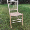 7 spindle back dining chair with knotty features and paper rush seat